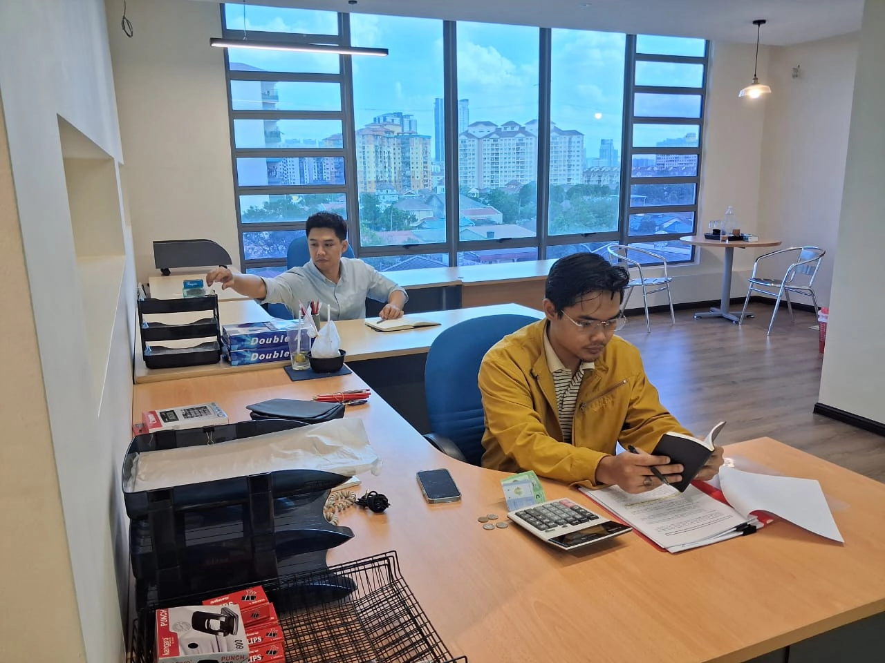 Two members of the Suria Crestway team at work in the company's office