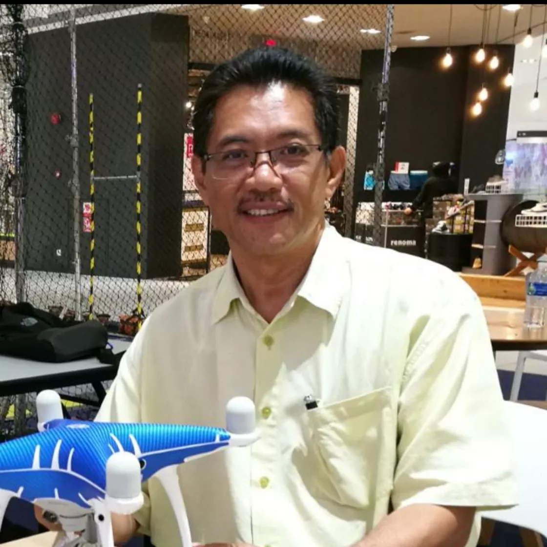 A member of the Suria Crestway team with survey equipment