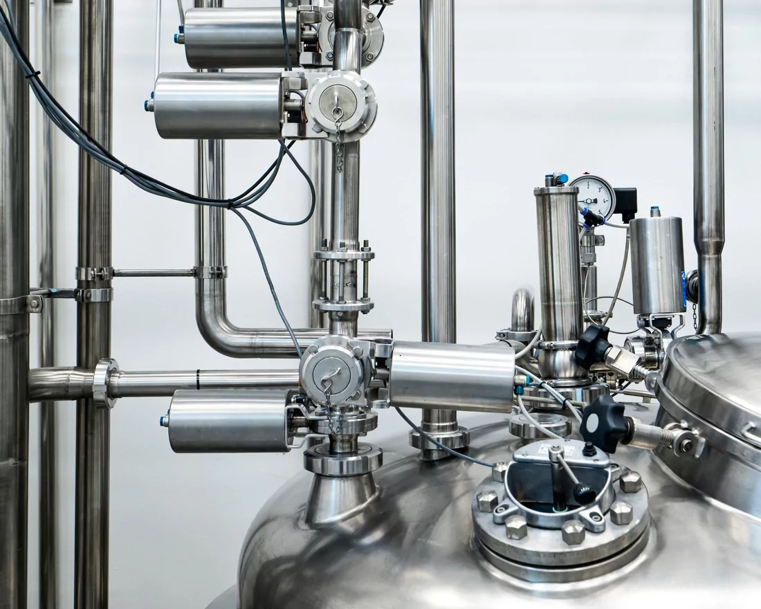 Stainless steel process pipework and valves inside a plant
