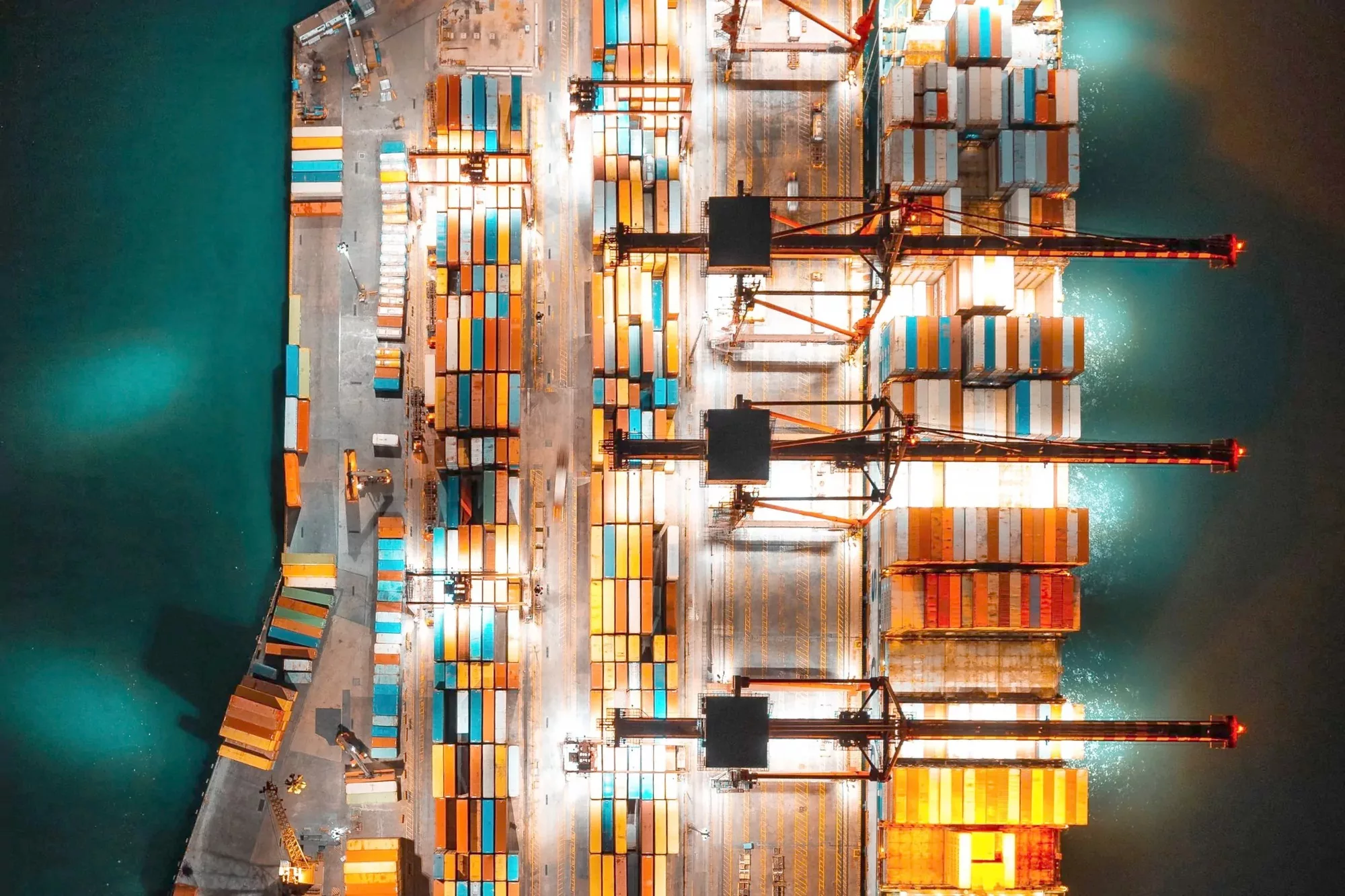 Container terminal lit at night seen from directly above