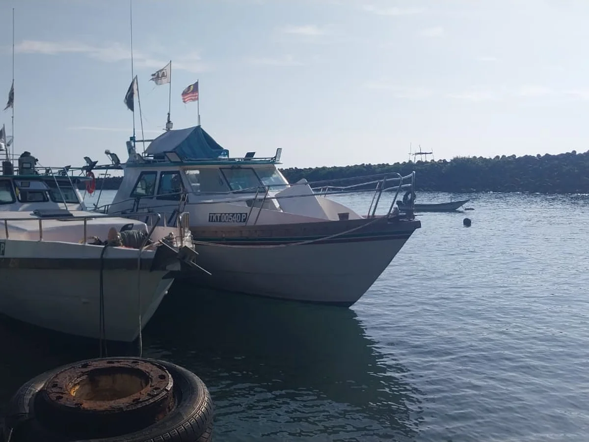 Work boats moored alongside the jetty