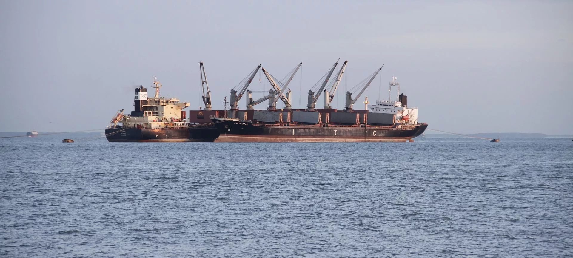 Bulk carrier lying at anchor in open water
